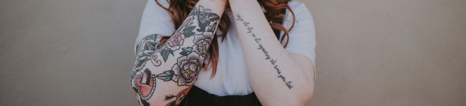 A woman with colorful cool temporary tattoos on both of her arm