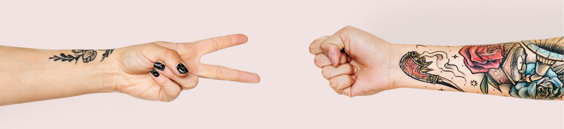 hand with cute temporary tattoo playing rock paper scissor