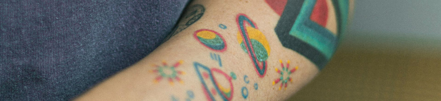 A man displaying a Temp Tattoo For Sale'design on his arm